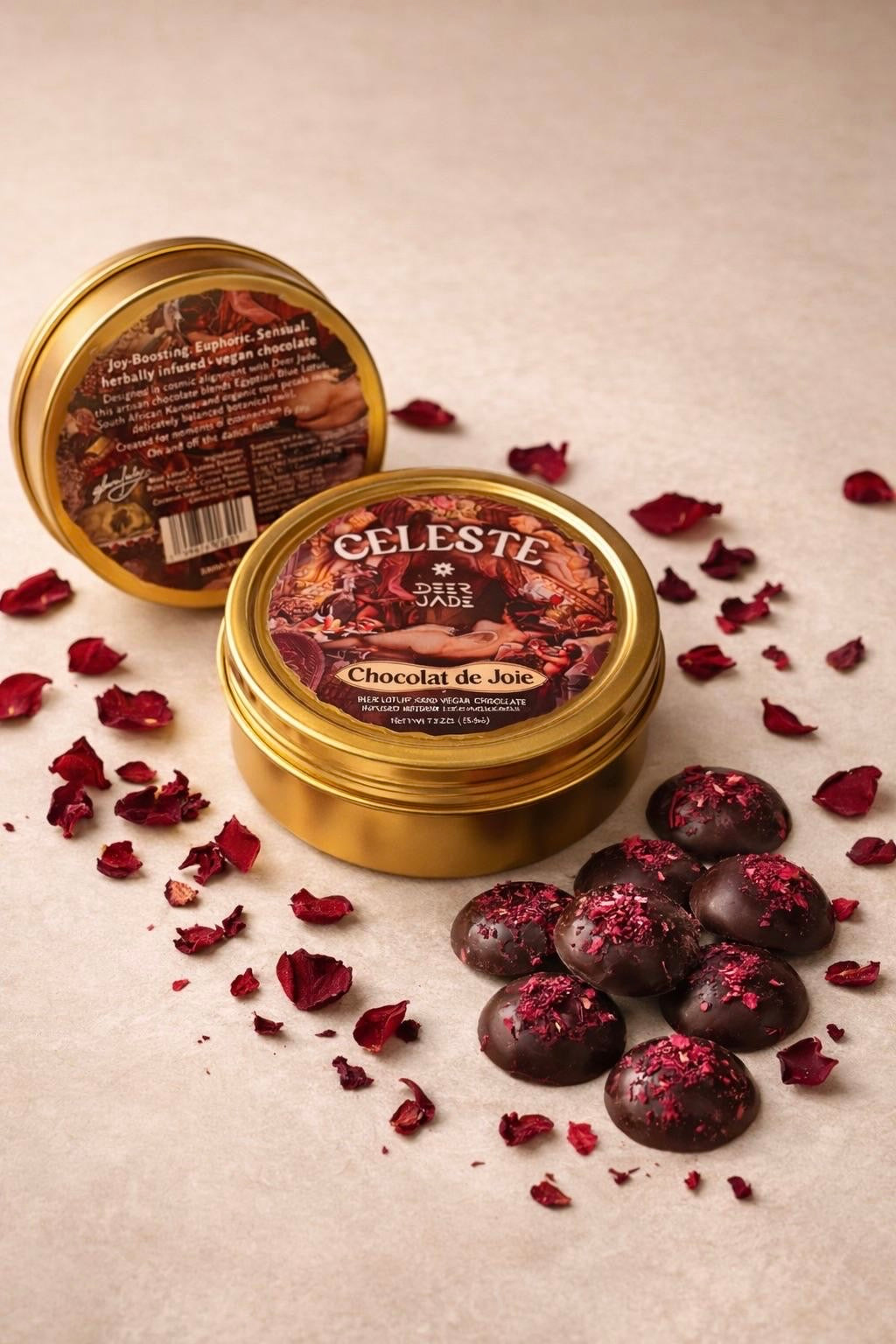 Two tins of Chocolat de Joie with kanna chocolate pieces topped with dried rose petals